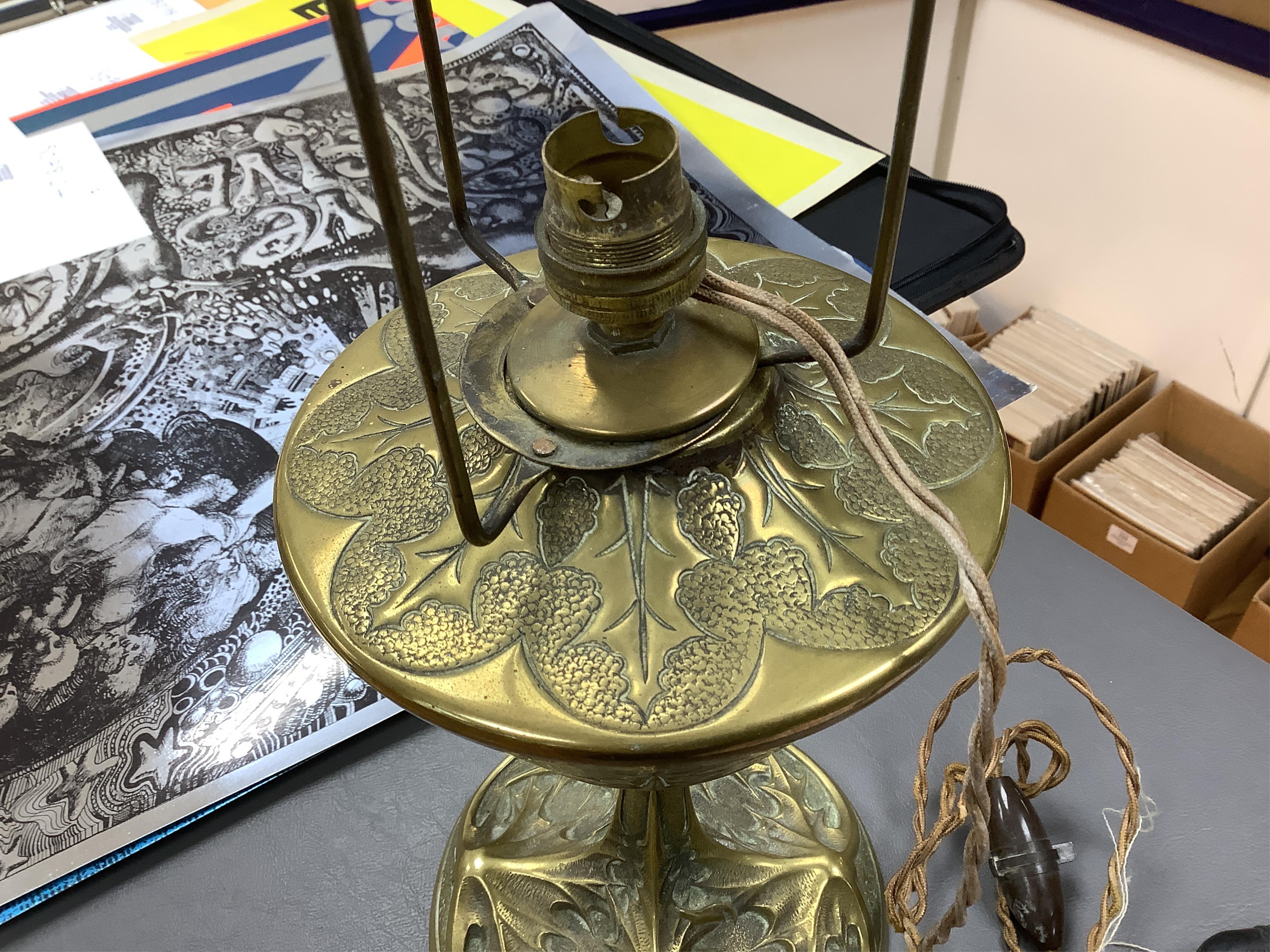 After Georges Leleu, an Art Nouveau brass oil lamp converted to electricity, with glass cabochon roundels and beaded fringing, 50cm high